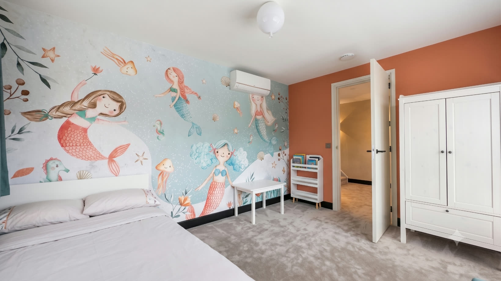 Children's bedroom with a hand-painted wall mural