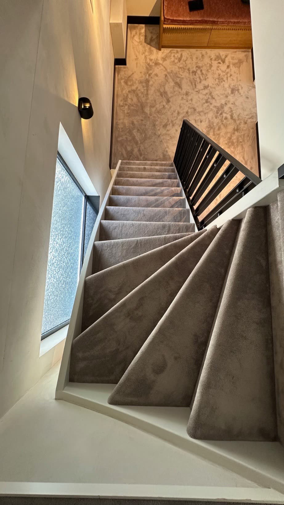 Carpeted staircase to the second floor